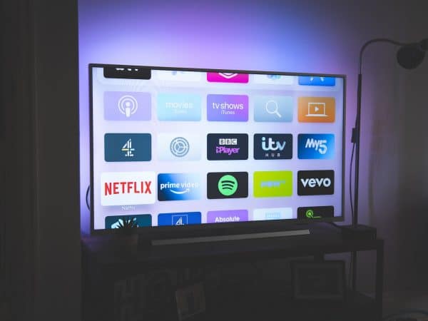 black flat screen tv turned on showing game